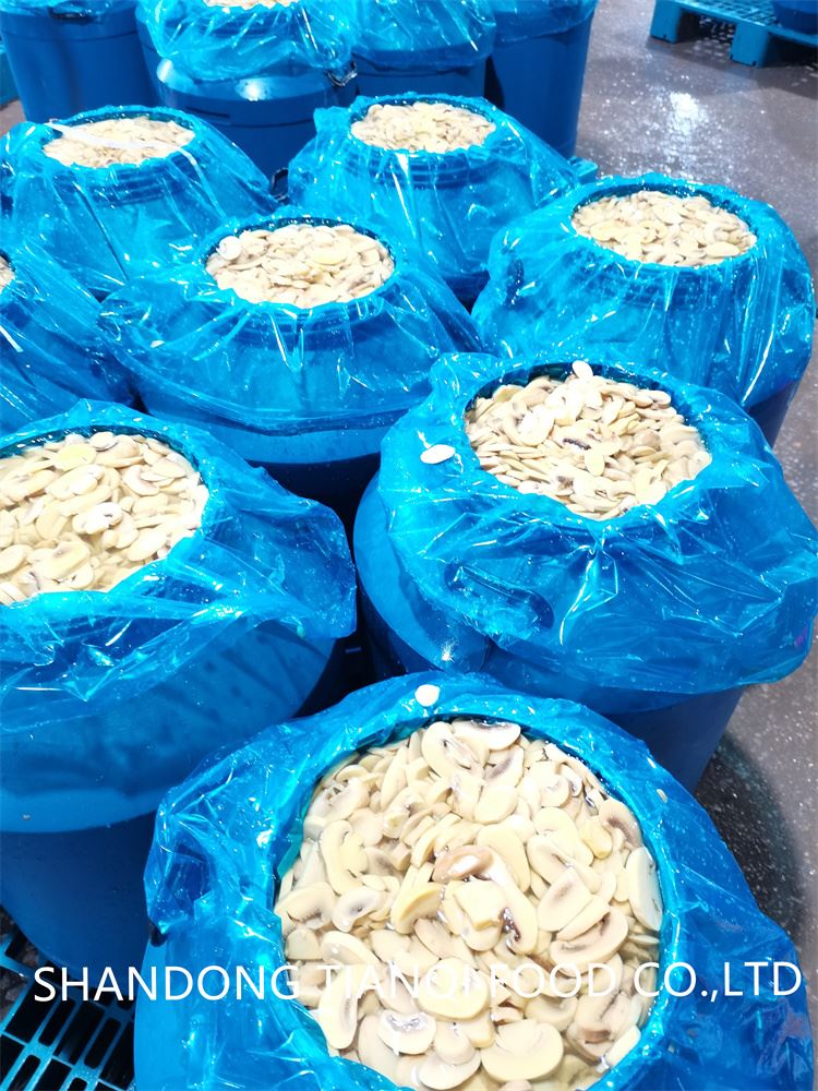 high quality sliced champignon mushroom in salted water in drums