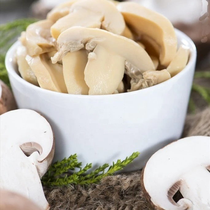 Sliced white champignon in salty water in drums
