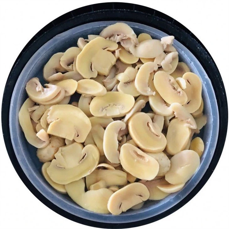 Sliced champignon mushroom in brine in plastic drums