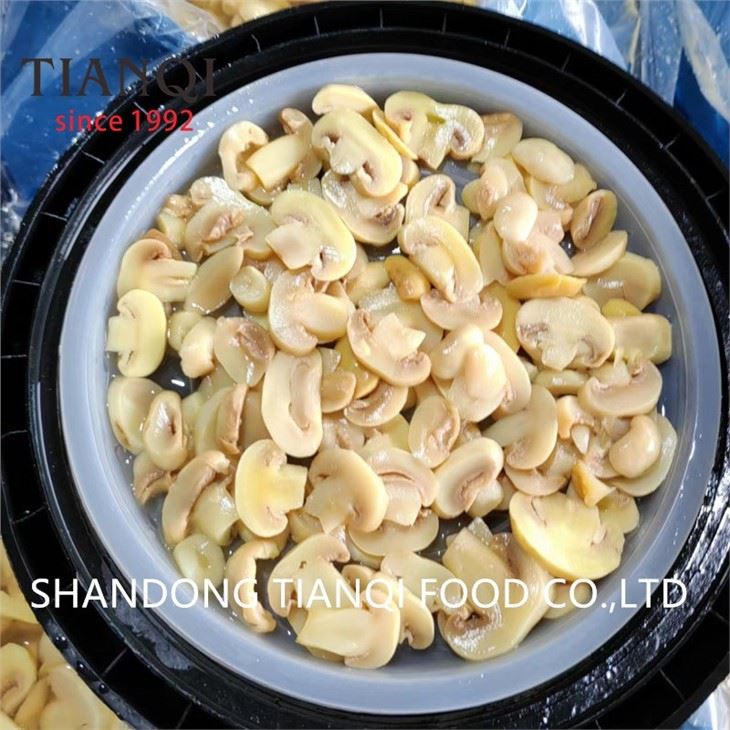 Slice white mushroom in brine in drums